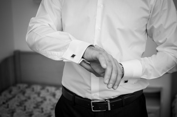 Fototapeta premium Man fastening a cuff-link on the shirt