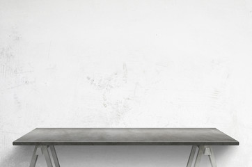 Clean gray table front of white concrete wall