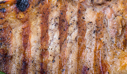 Large piece of fresh pork meat on a bone prepared on a grill pan