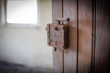 geöffnete alte Holztüre, mit altem rostigem Türgriff