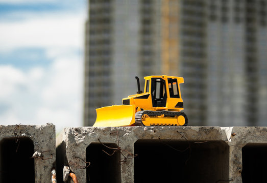 Toy bulldozer in the construction site