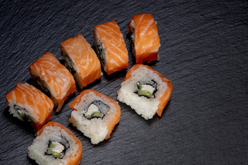 Close up delicious Japanese food sushi over dark background with copy space