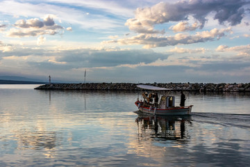Fototapeta premium Traditional fishing boat exiting the port of Platamonas.