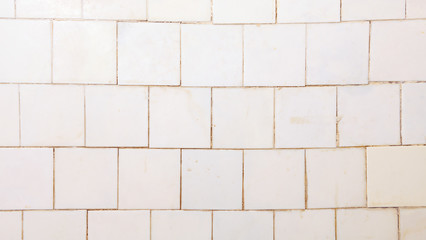 Bright vintage wall made of white plastic tiles.White or gray plastic wall and tile abstract background.