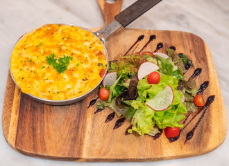 baked potatoes with cream and cheese with salad on Chopping Wood