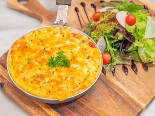 baked potatoes with cream and cheese with salad on Chopping Wood