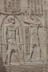 Hieroglyphic carvings on an ancient egyptian temple wall