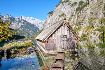 The beautiful Obersee in the Bavarian Alps with a wooden boathouse