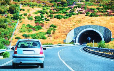 Car on road with underpass in Cagliari Sardinia reflex
