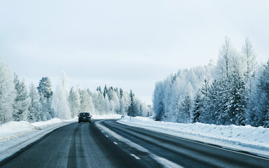 Landscape of car in road in snowy winter Lapland reflex