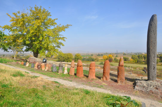 Menhirs and a stone-vishap stand in a row on the territory of the Metsamor Museum-Reserve. Armenia