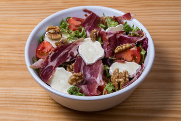 Fresh salad with cheese, nuts and ham