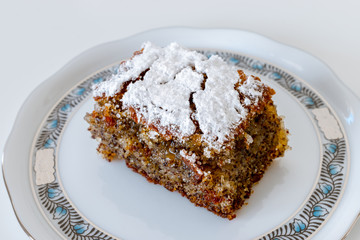 One slice of a traditional Hungarian poppy seed cup cake on a Herend porcelain plate.