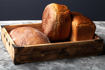 Composition with a bread on a textured plastered surface
