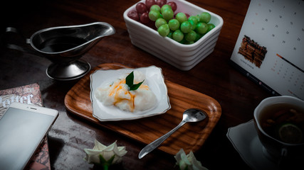 Bubur sumsum, an indonesian traditional dish served on small white plate and wooden tray