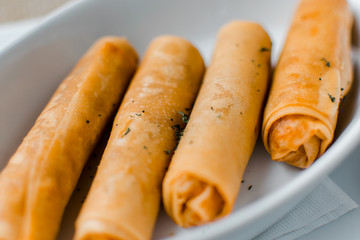 Risol indonesian street snack close up with garnish on white bowl