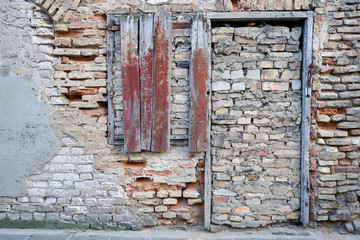 Old brick wall with door bricked up so nobody could enter