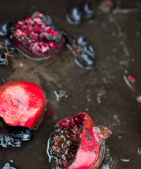 Rotten pomegranates and grapes.