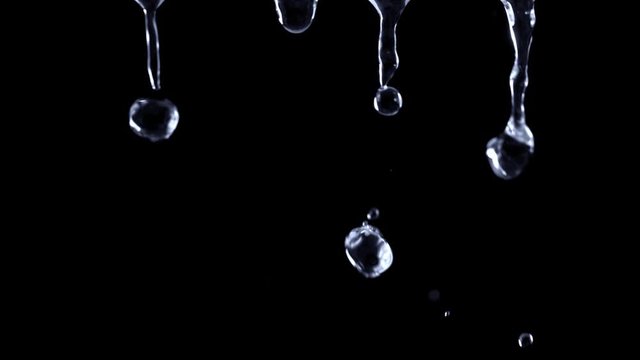 Super Slow Motion Shot of Falling Water Droplets Isolated on Black Background at 1000 fps.