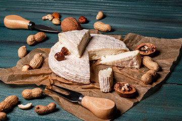 Fototapeta na wymiar White cheese brie or camembert. The concept of oriental cuisine. National Italian French Gourmet appetizer cheese and nuts