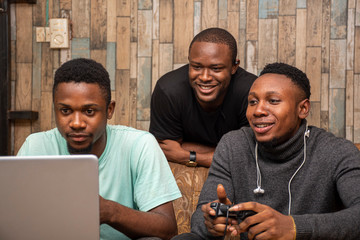 young african friends playing video games together