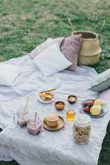 Fototapeta na wymiar Beautiful cozy summer or spring picnic with cocoa, pancakes, honey, strawberries, pears and granola.