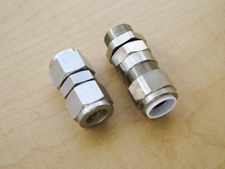 Explosion proof cable gland isolated on wood background