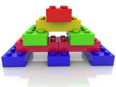 Colored toy brick pyramid with red brick at the top