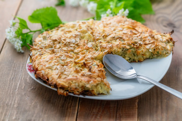 Lazy pie with cabbage and dill according to the Turkish recipe on a wooden table