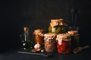 Vegetables and fruits canning. Glass jars with fermented, pickled and canned vegetables and fruits...