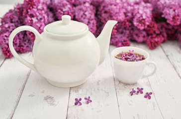 Good morning concept. Cozy morning. Tea set and lilac flowers. Happy birthday greeting card. Hello spring and summer. Greeting card for Women's Day and Mother's Day. Spring season, copy space