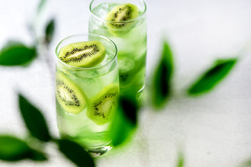 Glass of Refreshing Tropical Kiwi Lemonade With Ice on Light Gray Background Tasty Summer Beverage Healthy Detox Diet Drink