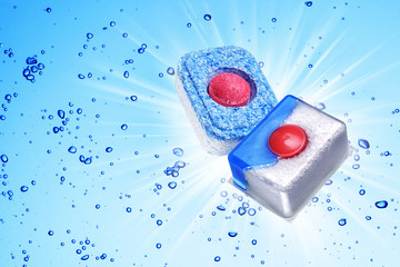 Dishwasher detergent tablet under blue water