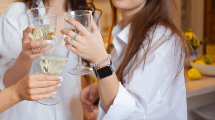 There's toast. A group of female friends in white shirts clink glasses with champagne.