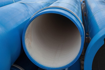 Stack of new blue pipes (tubes)