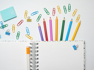 School note and supplies on a white background. Back to school, home creative workspace
