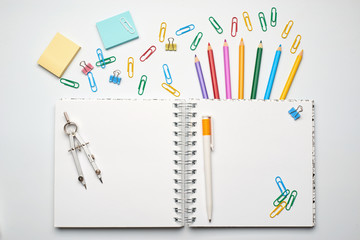 School note and supplies on a white background. Back to school, home creative workspace