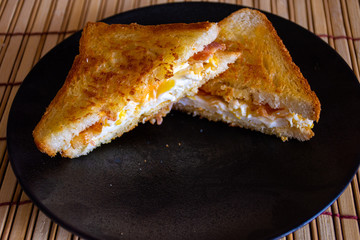 Sandwich with Egg, Bacon, Cheese and Spicy Sauce