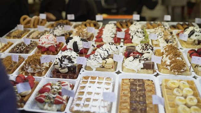 All sorts of delicious brussels waffles in a waffle store in Brussels Belgium. Waffles with chocolate, chantilly, sugar, fruit, ...