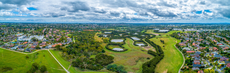Obraz premium Aerial panorama of Tirhatuan Wetlands and Rowville suburb in Melbourne, Australia