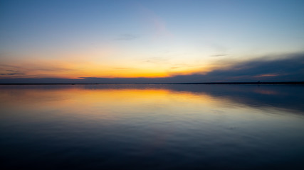 Sunset on the sandy beach, beach, beautiful sky, dramatic sky, sky reflected in the water.