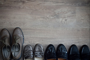 Loafers and other shoes retro style stand on the wooden floor.