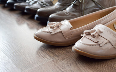 Loafers and other shoes retro style stand on the wooden floor.