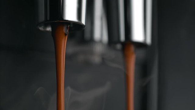Fresh Brewed Steaming Coffee Flowing out of Espresso Machine&rsquo;s Double Portafilter Spout