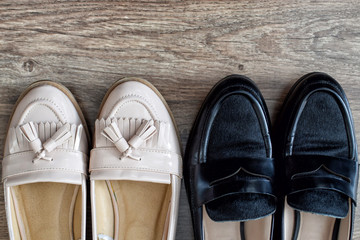 Loafers and other shoes retro style stand on the wooden floor.