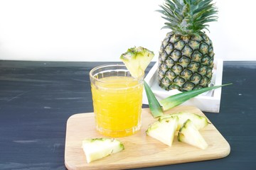 Fototapeta na wymiar Pineapple juice is a fruit and herb on the table.