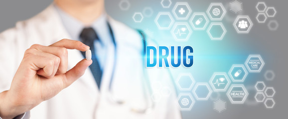 Close-up of a doctor giving you a pill with DRUG inscription, medical concept