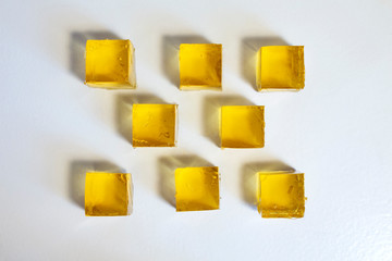 Apple jelly cubes on a white table