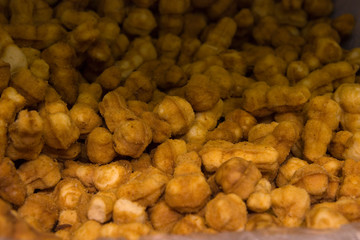 a lot of small biscuit cookies with filling on the counter of the bakery section of the store