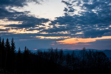 sunrise in the mountains with forest in the foreground with beautiful sky, czech republic beskydy Javorovy vrch